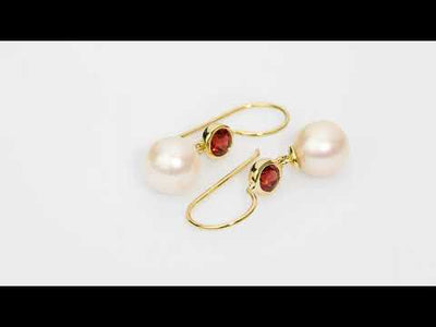 Video of 8mm Freshwater Cultured White Pearl and Garnet Fish Hook Earrings in 14K Yellow Gold.  Includes a Peora gift box. Free shipping, 45-day returns, authenticity guaranteed. E19352